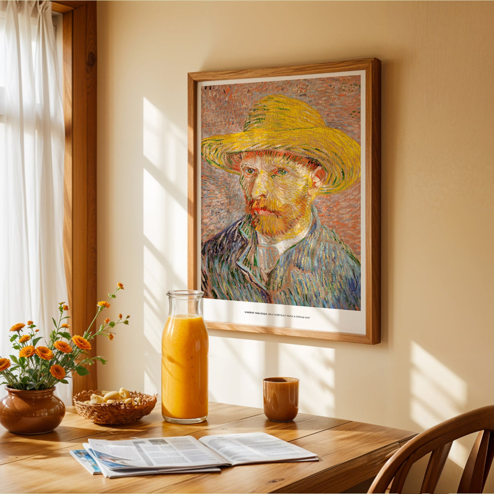 Framed Van Gogh painting above a wooden table with a glass of orange juice and flowers.