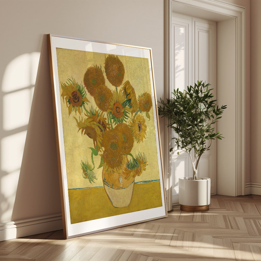 Framed artwork of sunflowers in a room with a plant and sunlight